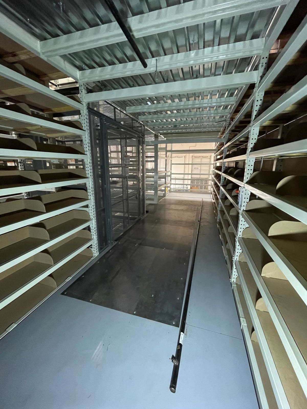 Walkway access between upper levels of high-density file storage shelving